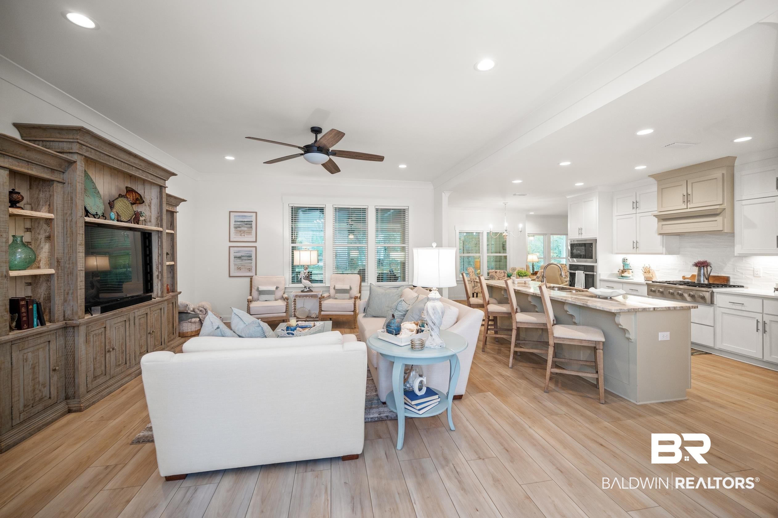 4601 Surrey Lane Orange Beach, AL 36561 - Photo 11 of 43 Living room featuring a healthy amount of sunlight, ceiling fan, and light wood-type flooring