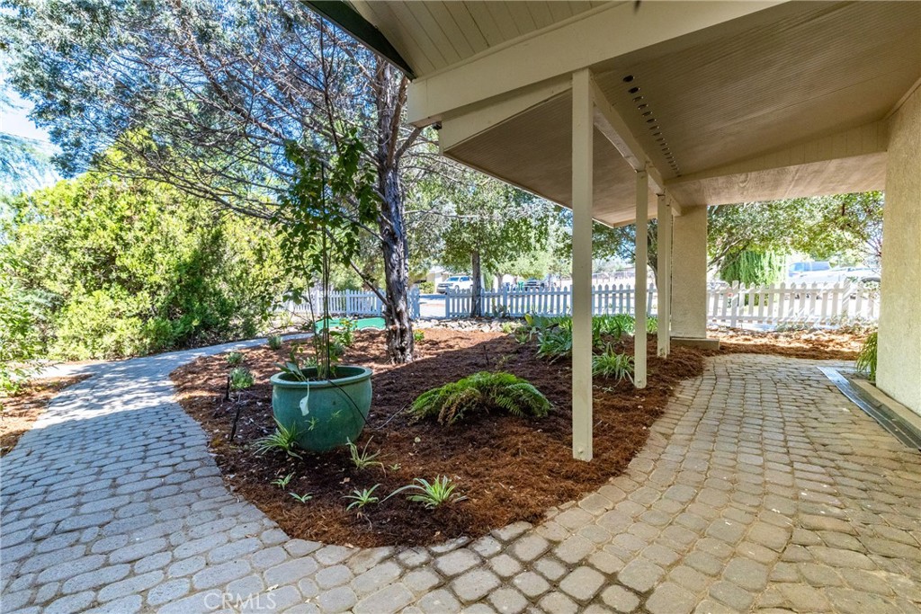 7990 San Gabriel Road Atascadero, CA 93422 - Photo 9 of 69 a view of a patio with table and chairs potted plants with floor to ceiling window
