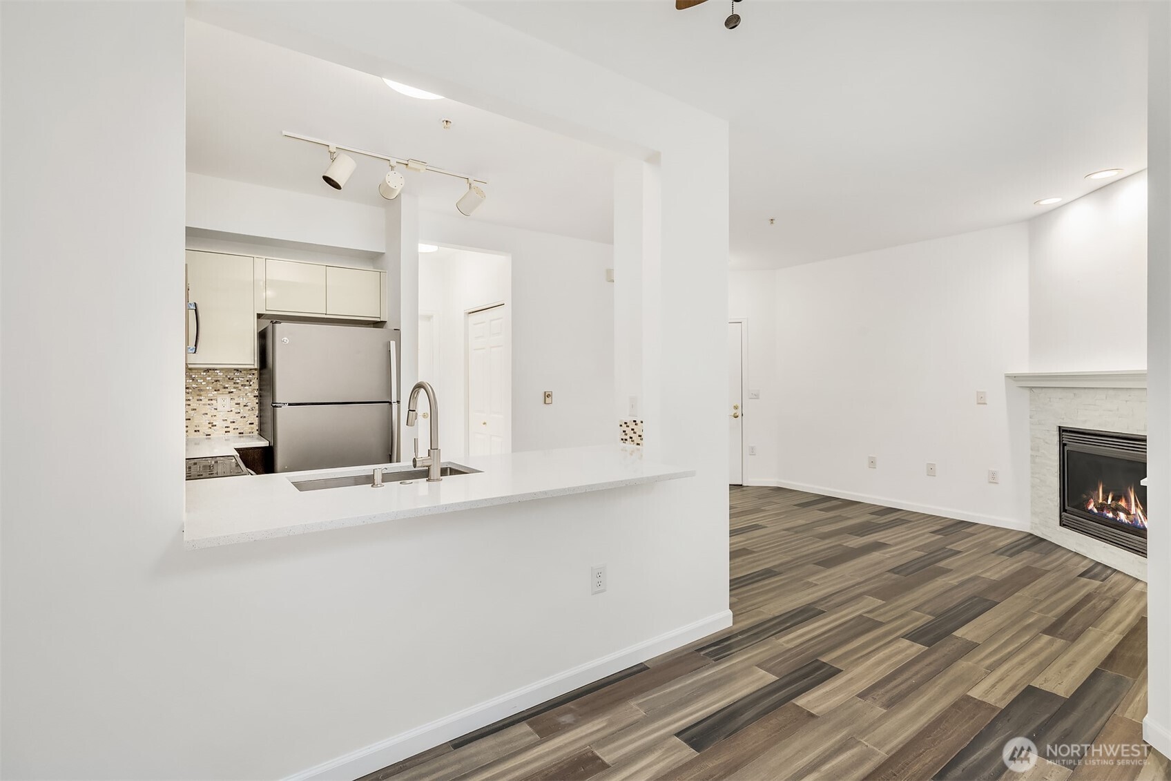 13000 Admiralty Way, Unit L104 Everett, WA 98204 - Photo 9 of 21 an empty room with cabinet and a fireplace