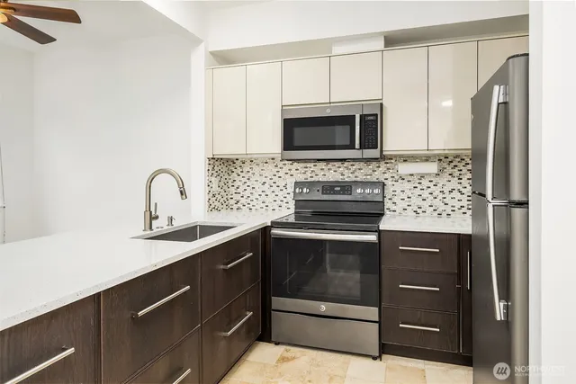 a kitchen with a sink appliances and cabinets
