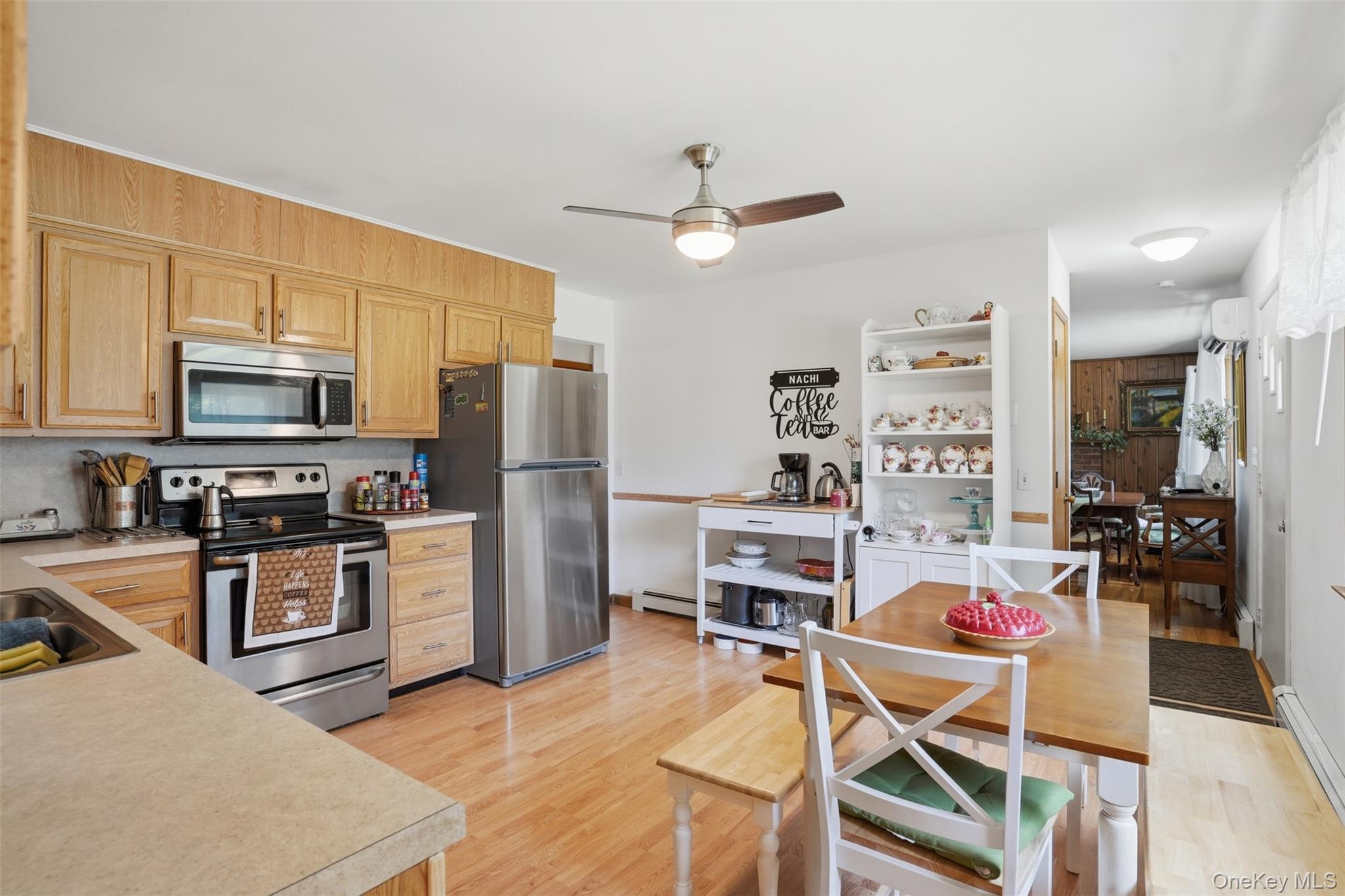 23 Dupay Road Pleasant Valley, NY 12569 - Photo 6 of 24 Kitchen featuring wood-finish flooring, light wood cabinetry, stainless steel appliances, and a ceiling fan with integrated lighting