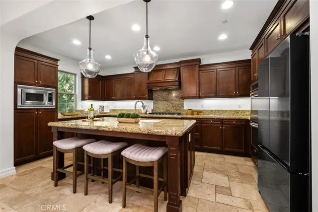 a kitchen with a counter space a sink appliances and cabinets