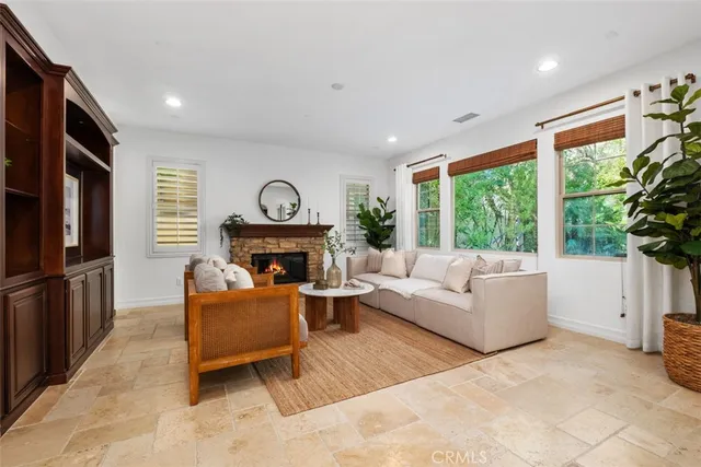 a living room with furniture a fireplace and a window