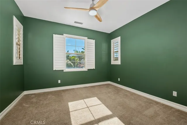 a view of room with window and ceiling fan