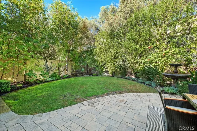 a view of backyard with swimming pool and green space