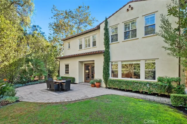 a view of a house with a patio and a yard