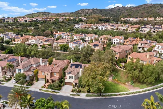 an aerial view of residential houses with outdoor space and river