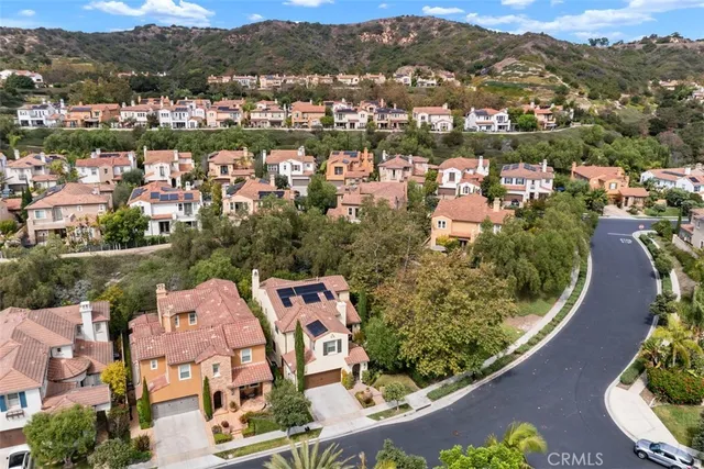 an aerial view of residential houses with outdoor space and river