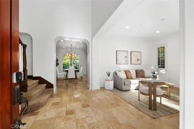 a living room with furniture and a chandelier