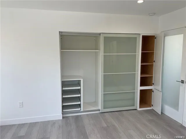 a view of an empty room with a closet