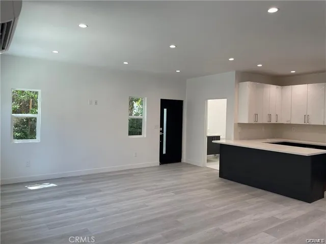 a view of kitchen with refrigerator and window