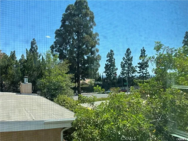 a aerial view of a house with a yard and potted plants