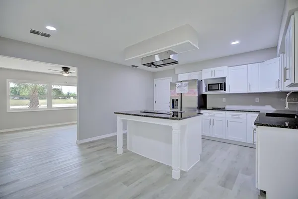 a kitchen with stainless steel appliances granite countertop a stove and a sink