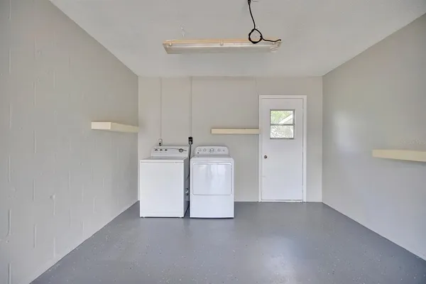 a view of storage and utility room with closet