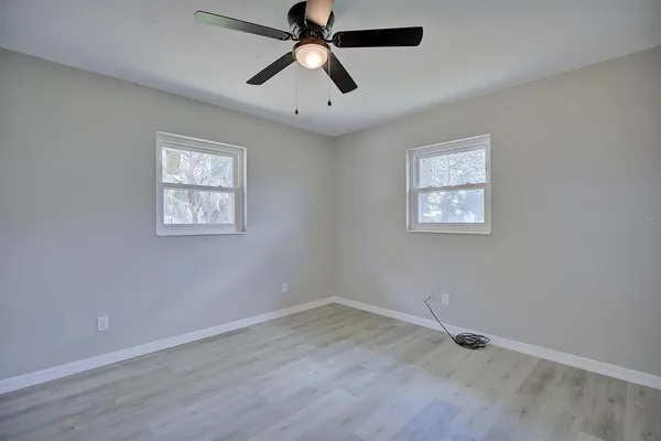 a view of empty room with wooden floor