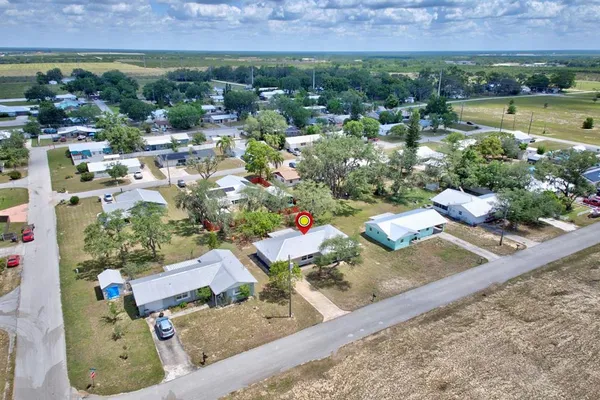 an aerial view of a house with a garden and lake view