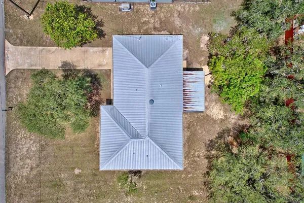 an aerial view of a house with a yard