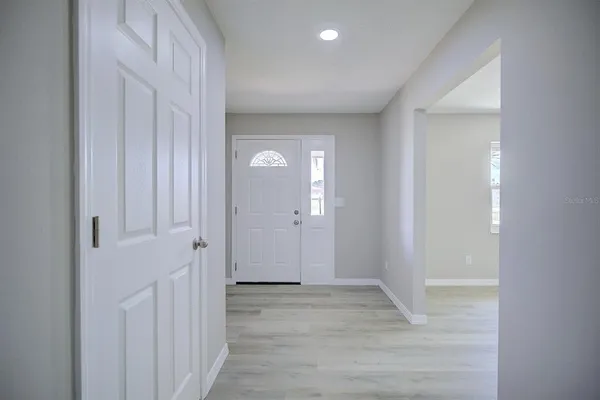 a view of a hallway with wooden floor