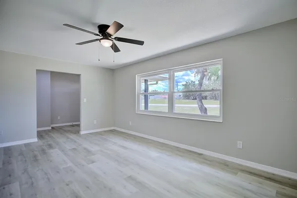 wooden floor in an empty room with a window