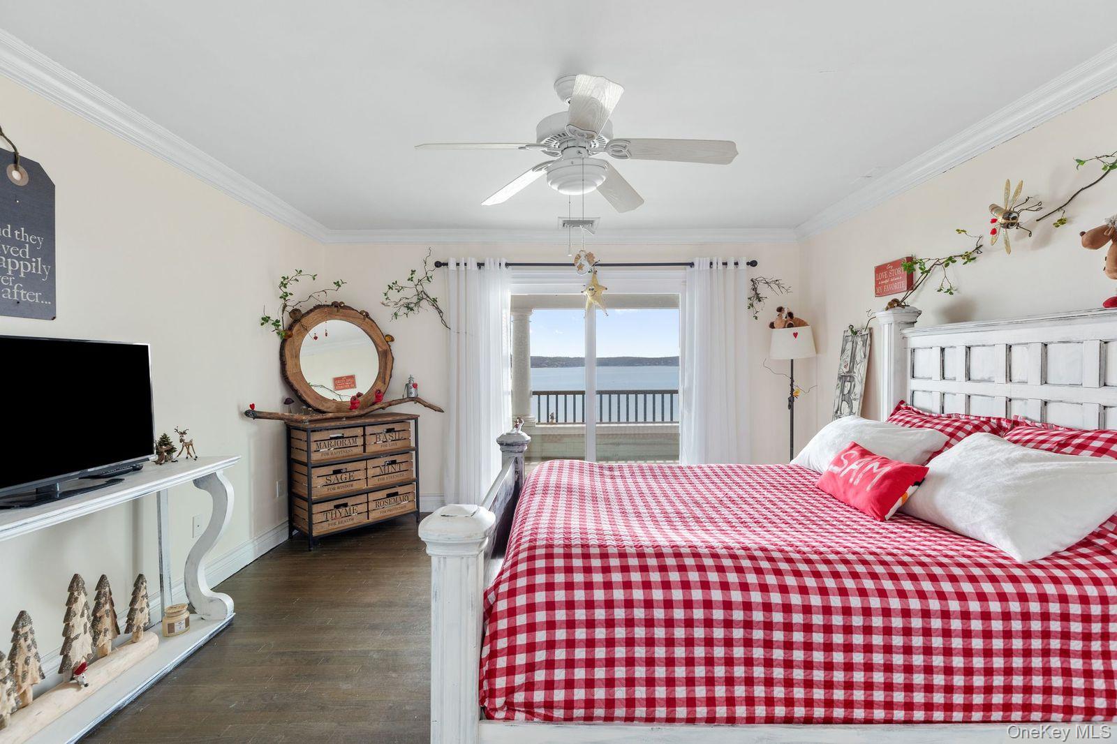 33 Beach Road Northport, NY 11768 - Photo 30 of 50 a bedroom with a bed and flat tv screen on the dresser