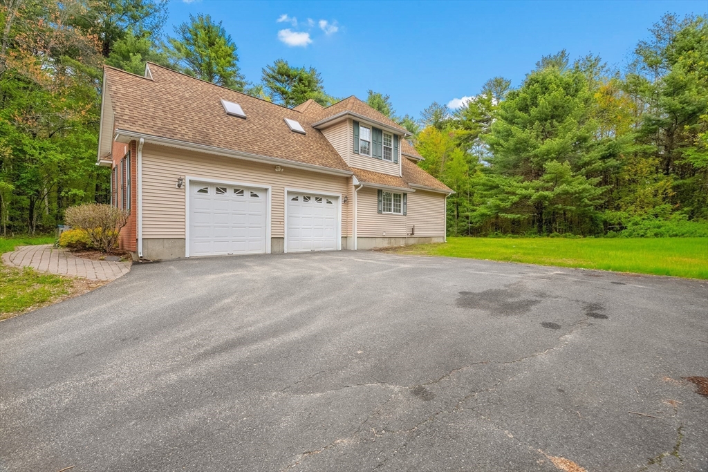 113 Greenwich Plains Road Ware, MA 01082 - Photo 3 of 42 a front view of a house with a yard and garage