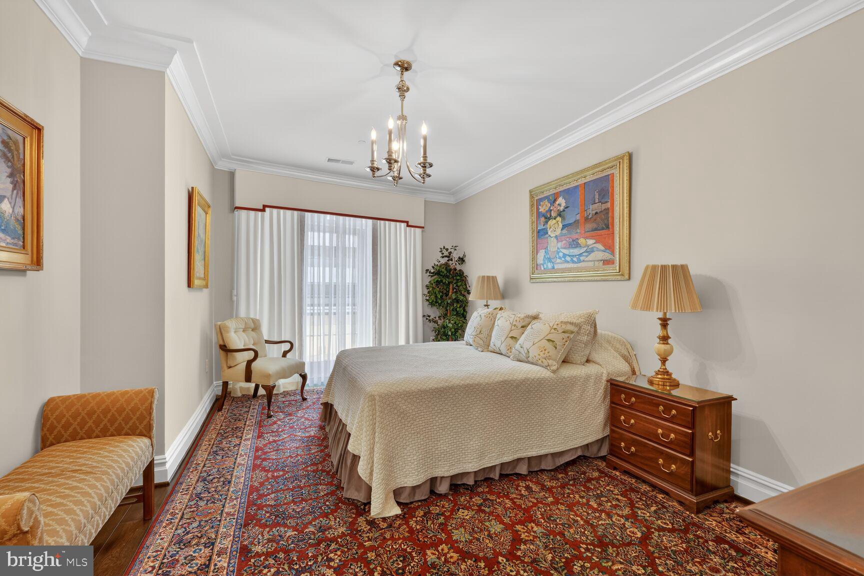 6900 Fleetwood Road, Unit 612 McLean, VA 22101 - Photo 24 of 42 a bedroom with a bed and a chandelier