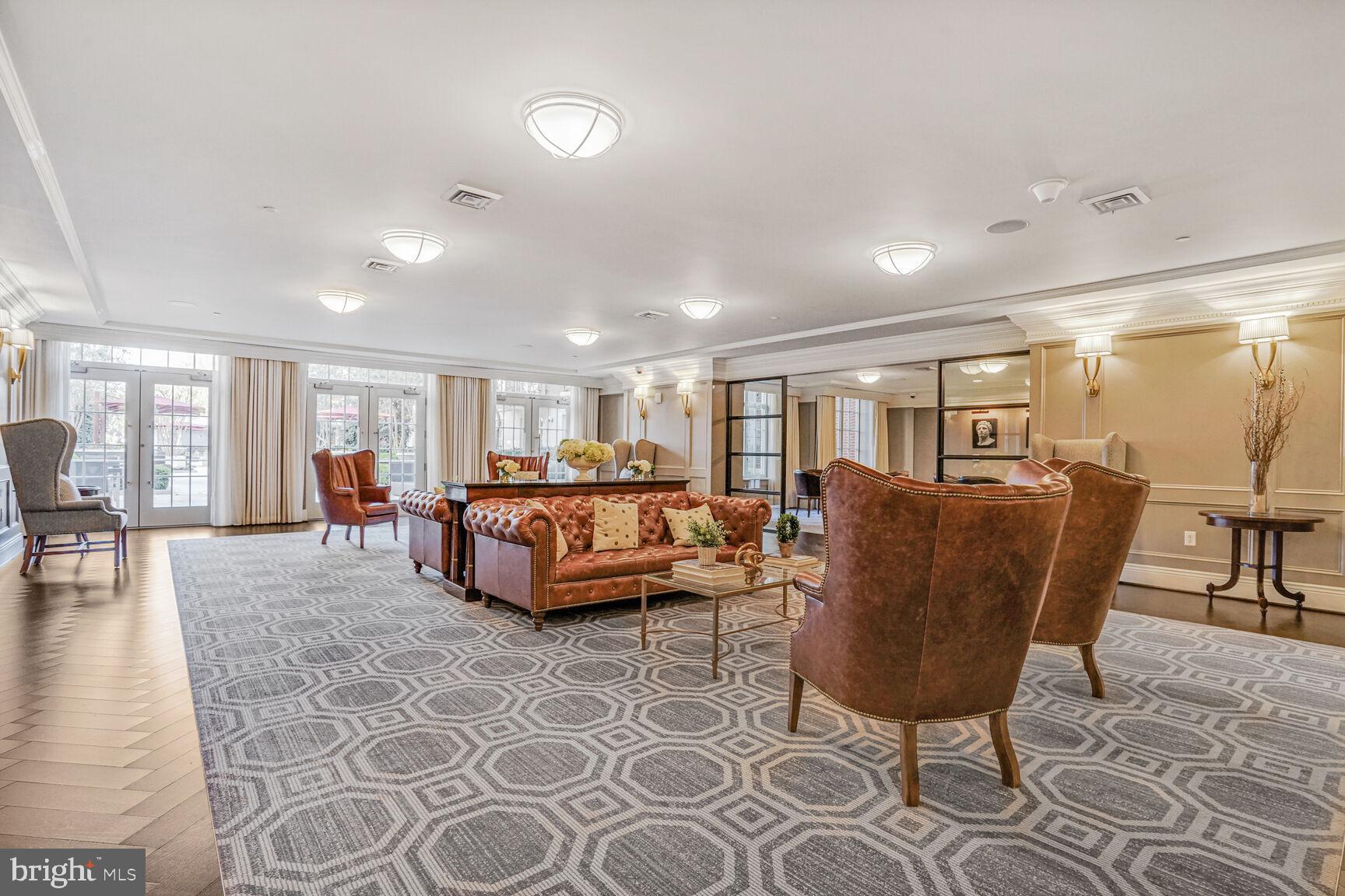 6900 Fleetwood Road, Unit 612 McLean, VA 22101 - Photo 6 of 42 a living room with furniture a dining table and a rug