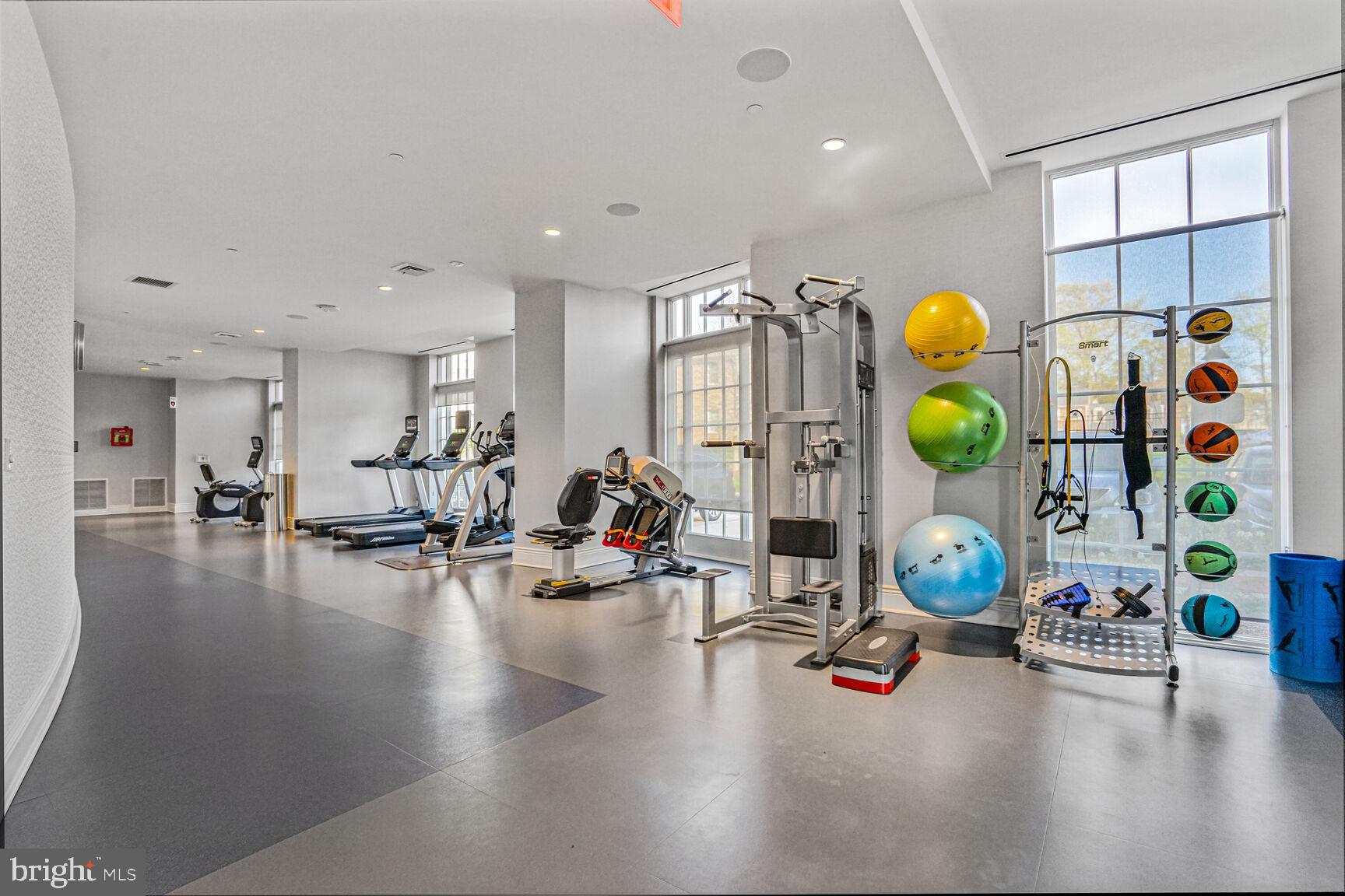 6900 Fleetwood Road, Unit 612 McLean, VA 22101 - Photo 7 of 42 a gym room with furniture and view of kitchen