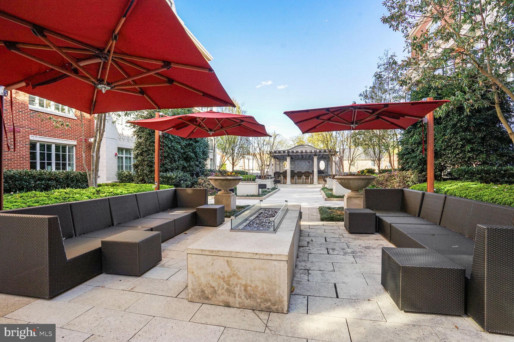 6900 Fleetwood Road, Unit 612 McLean, VA 22101 - Photo 10 of 42 a view of a patio with a table and chairs under an umbrella