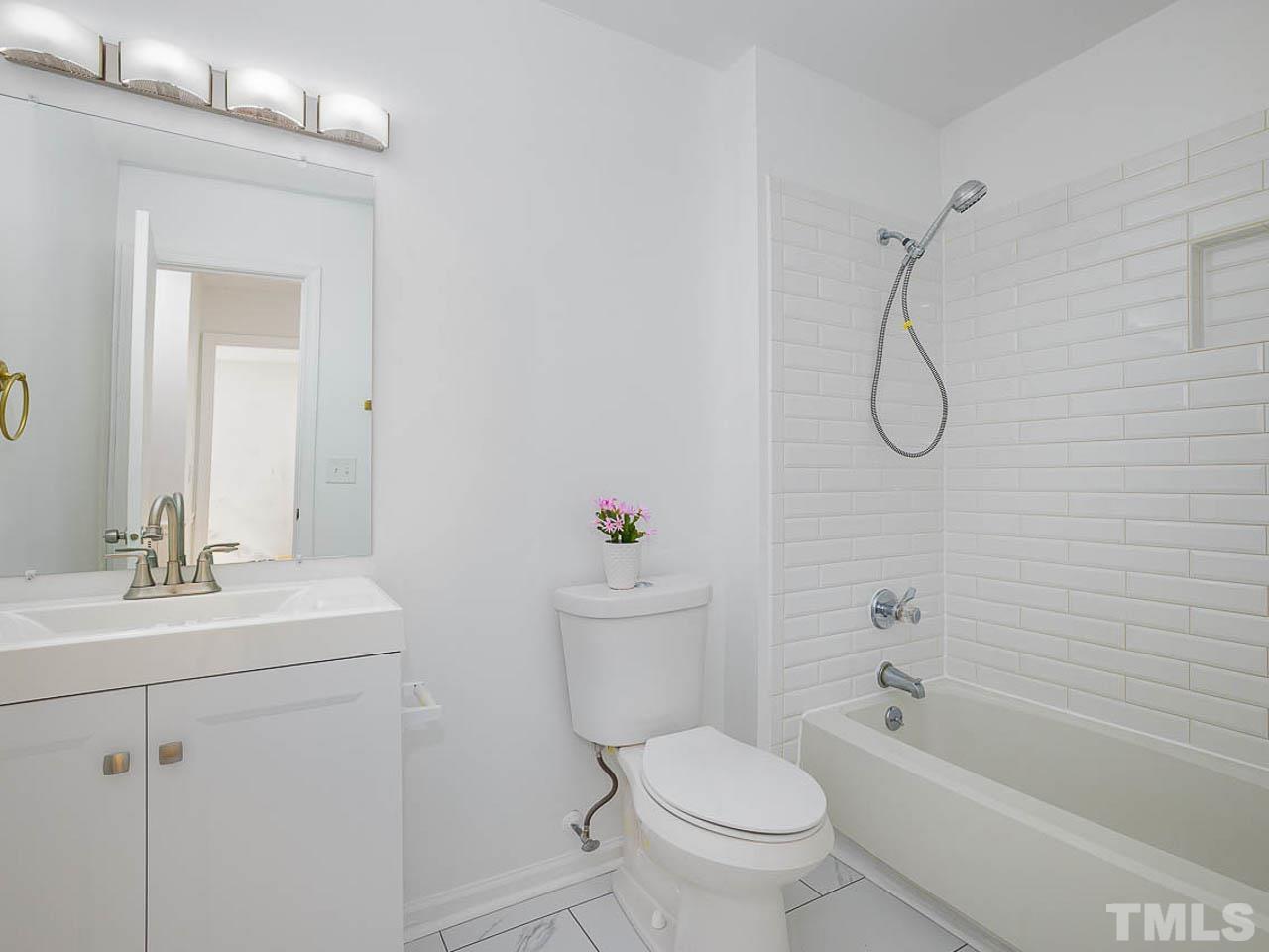 708 Sawmill Road Raleigh, NC 27615 - Photo 17 of 32 a bathroom with a sink toilet vanity and shower