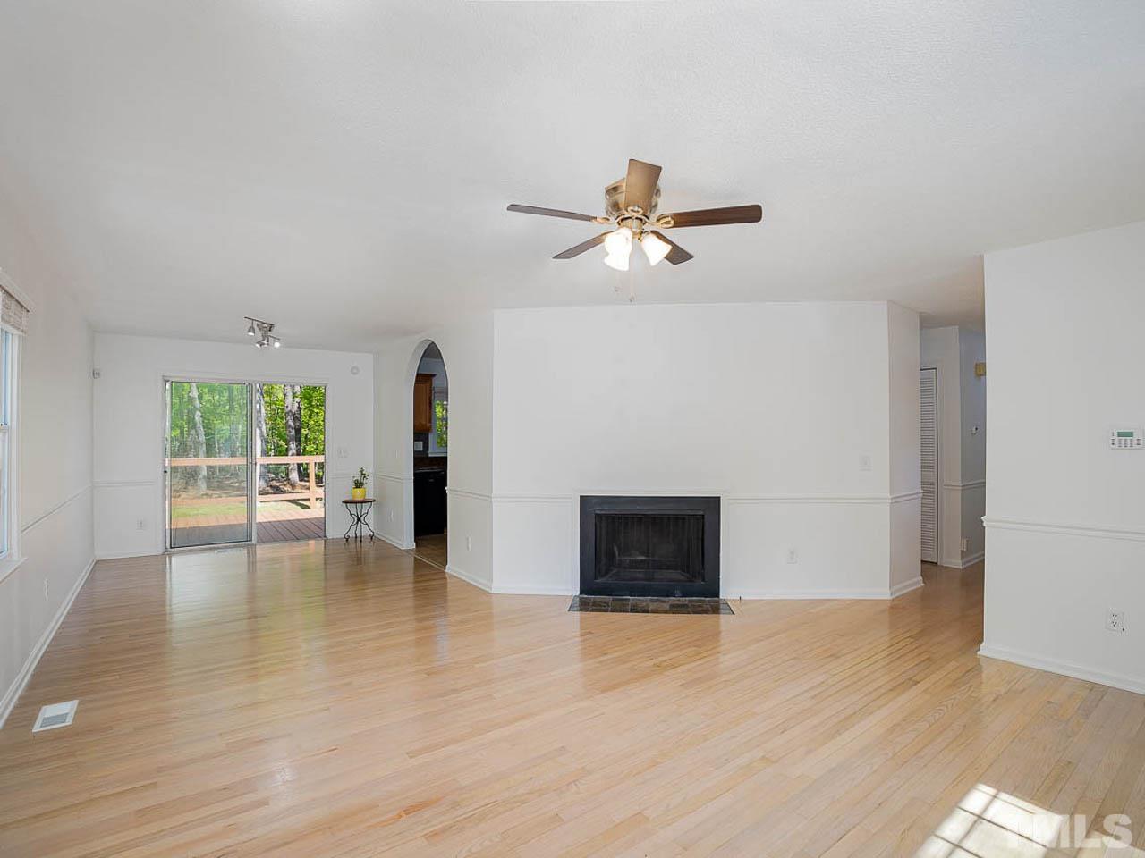 708 Sawmill Road Raleigh, NC 27615 - Photo 6 of 32 a view of empty room with wooden floor and fan