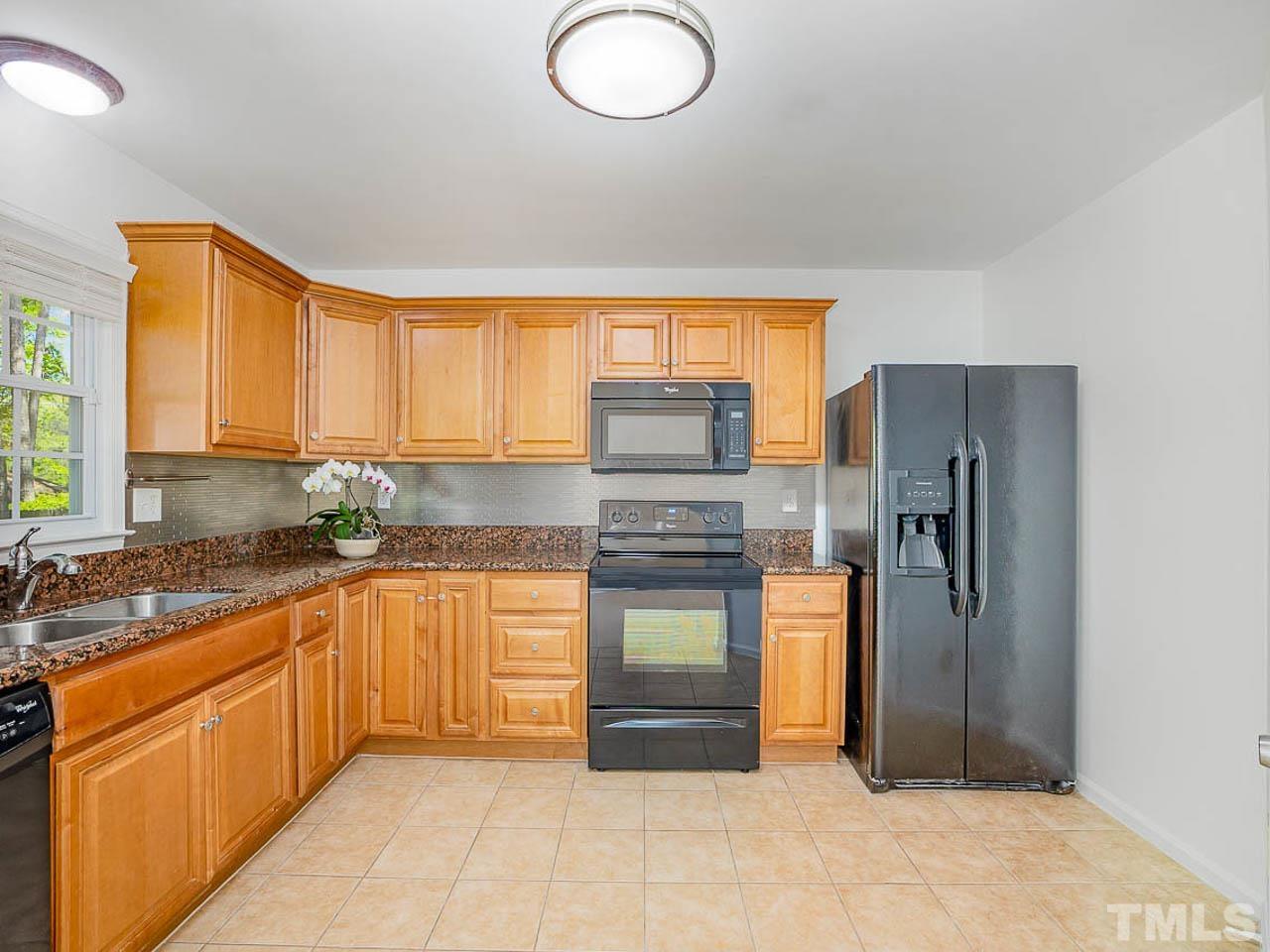 708 Sawmill Road Raleigh, NC 27615 - Photo 10 of 32 a kitchen with stainless steel appliances granite countertop a refrigerator and a sink