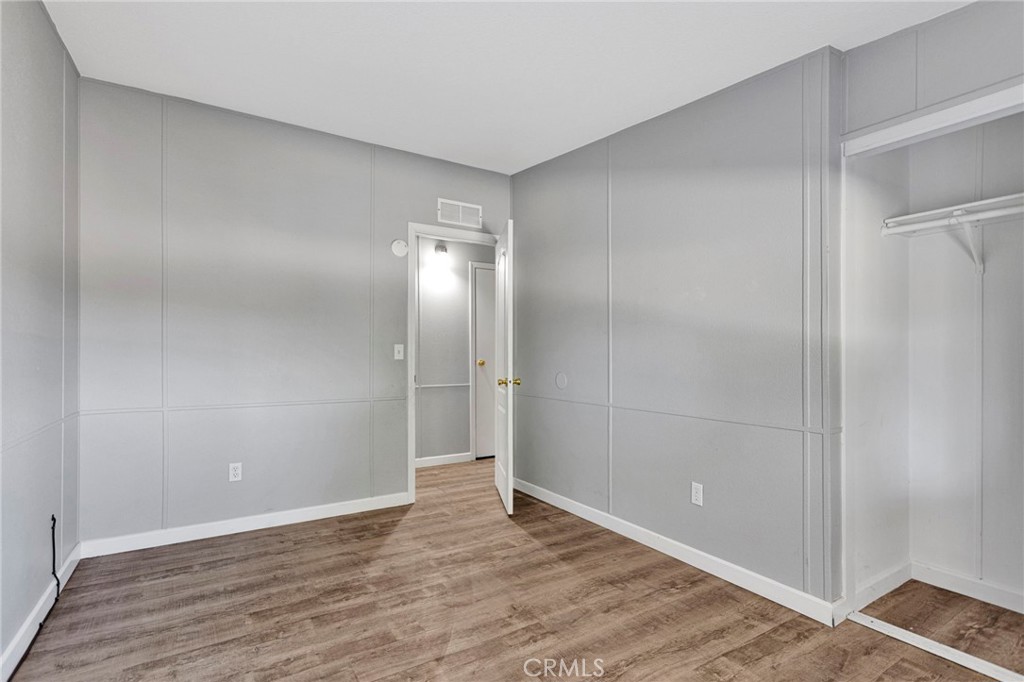 8074 Mira Mar Road Phelan, CA 92371 - Photo 19 of 49 a view of an empty room with wooden floor and closet