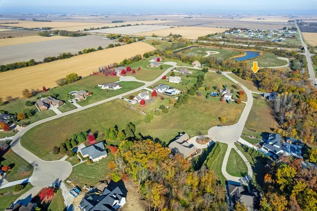an aerial view of a house with a lake view