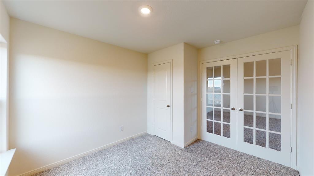 8012 White Sulphur Road Ponder, TX 76259 - Photo 16 of 39 Bedroom 3 - Unfurnished bedroom with french doors and carpet