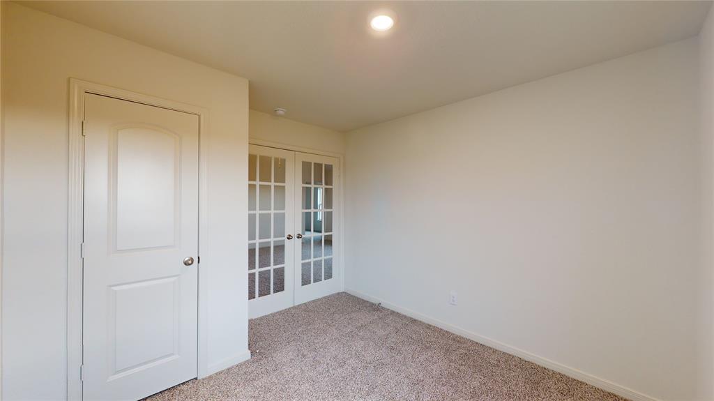 8012 White Sulphur Road Ponder, TX 76259 - Photo 18 of 39 Bedroom 3 - Carpeted spare room featuring french doors and baseboards