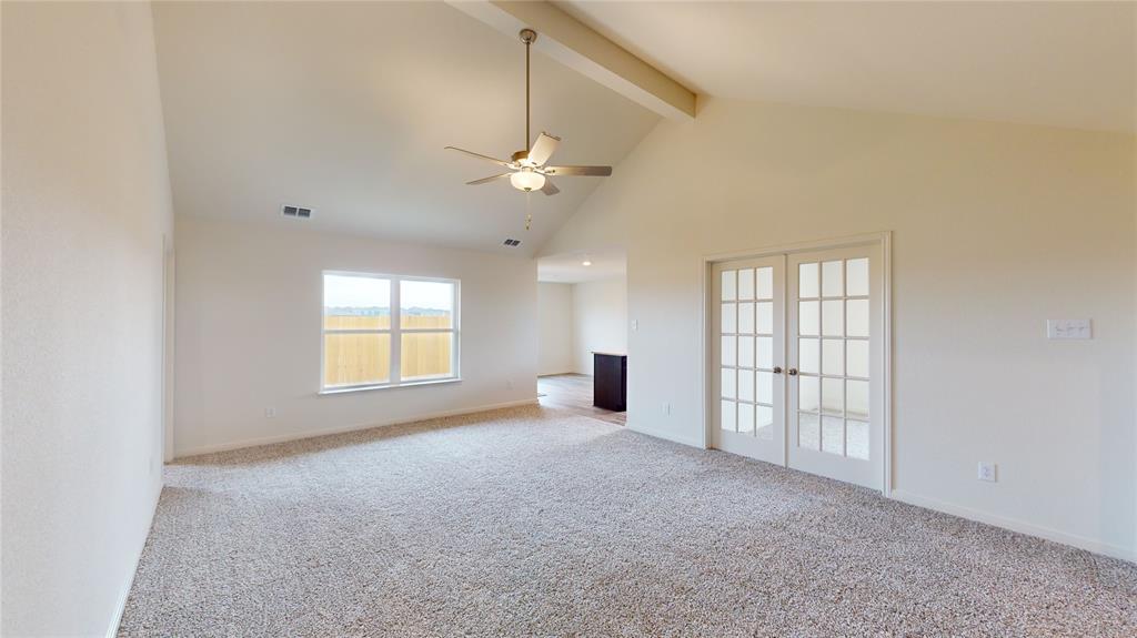8012 White Sulphur Road Ponder, TX 76259 - Photo 25 of 39 Unfurnished living room featuring high vaulted ceiling, beamed ceiling, carpet, french doors, and ceiling fan