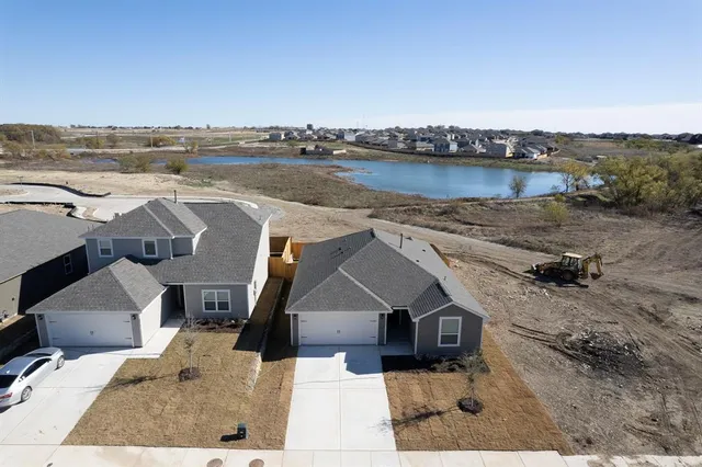 an aerial view of a house with a lake view