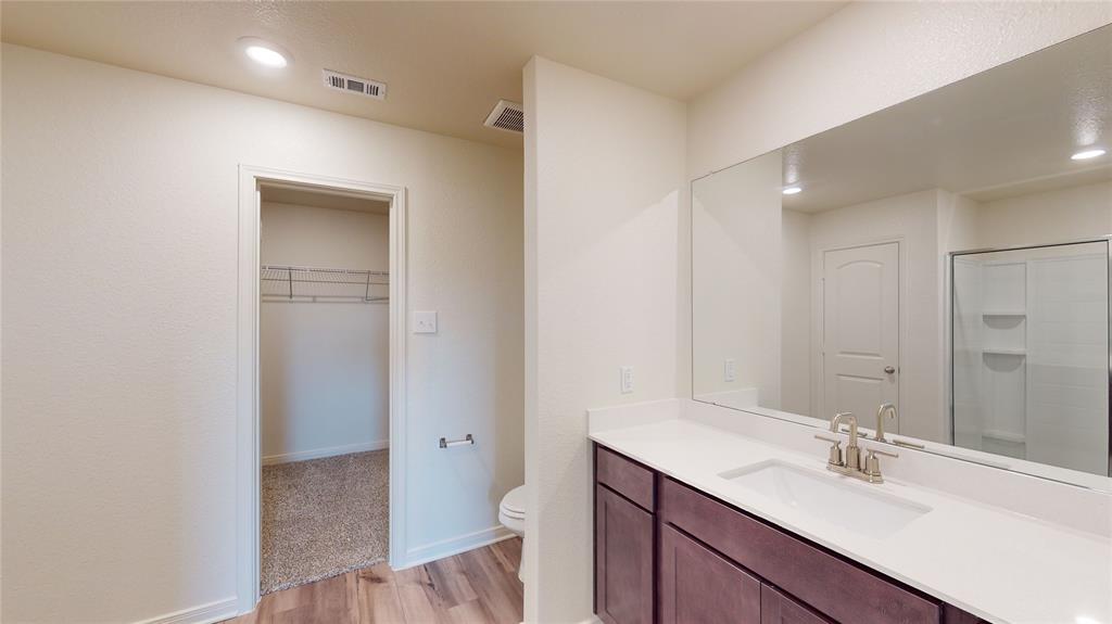 8012 White Sulphur Road Ponder, TX 76259 - Photo 31 of 39 Bathroom with a spacious closet, vanity, recessed lighting, light wood-type flooring, and a shower