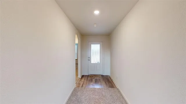 a view of hallway with wooden floor