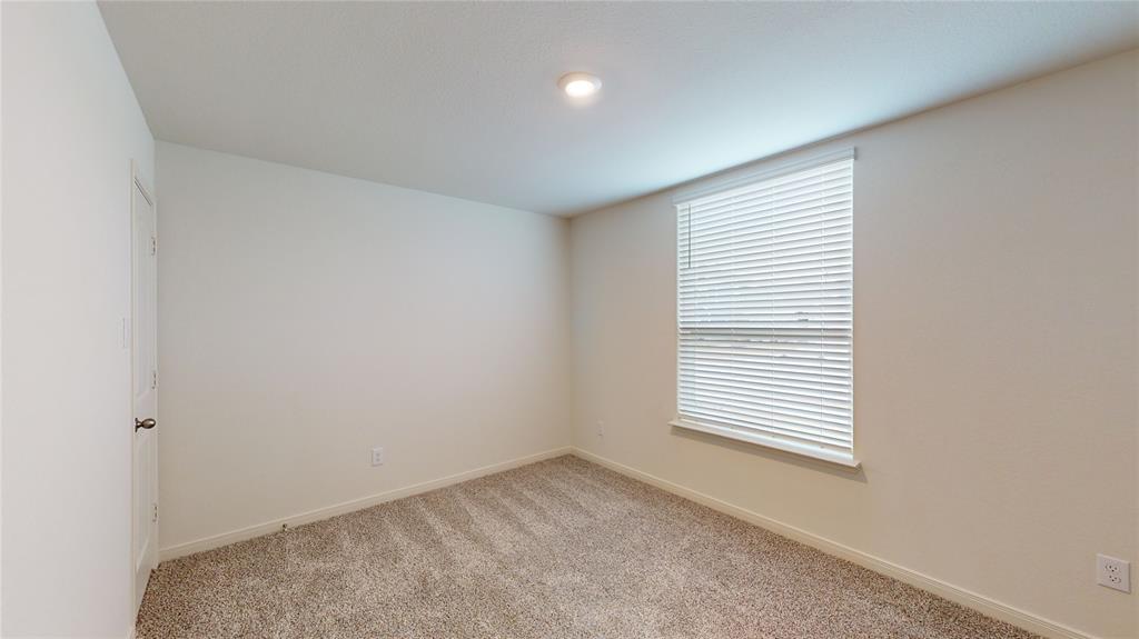 8012 White Sulphur Road Ponder, TX 76259 - Photo 7 of 39 Bedroom 1 - Carpeted spare room featuring baseboards