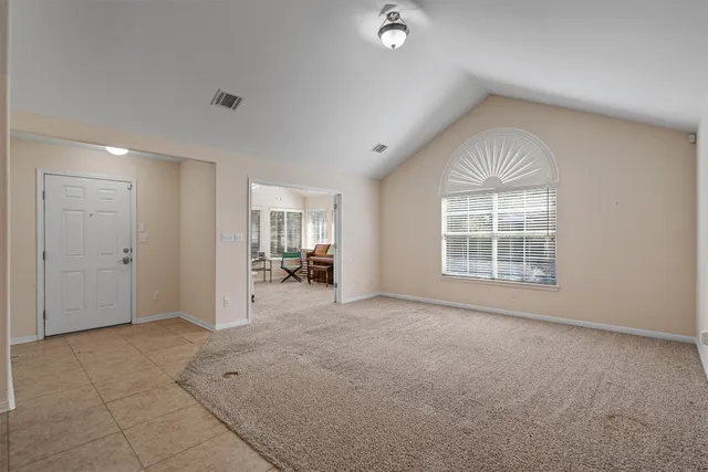 an empty room with windows and pillars in it
