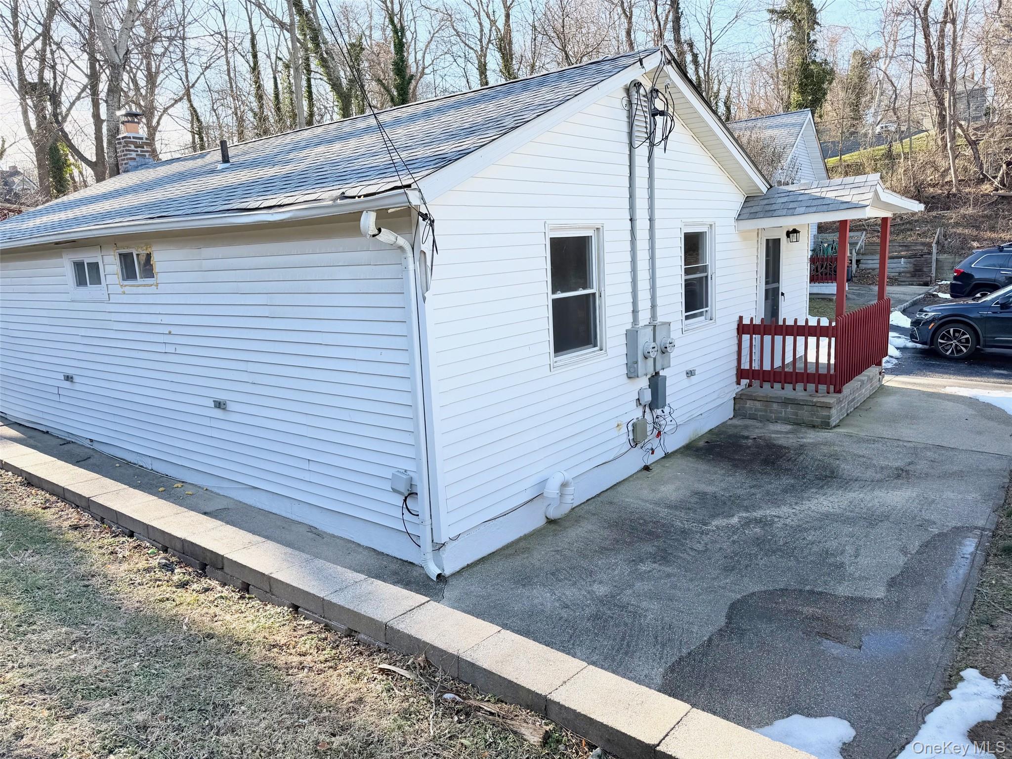 188 Hallock Landing Road Rocky Point, NY 11778 - Photo 15 of 25 View of property exterior featuring a shingled roof and a chimney