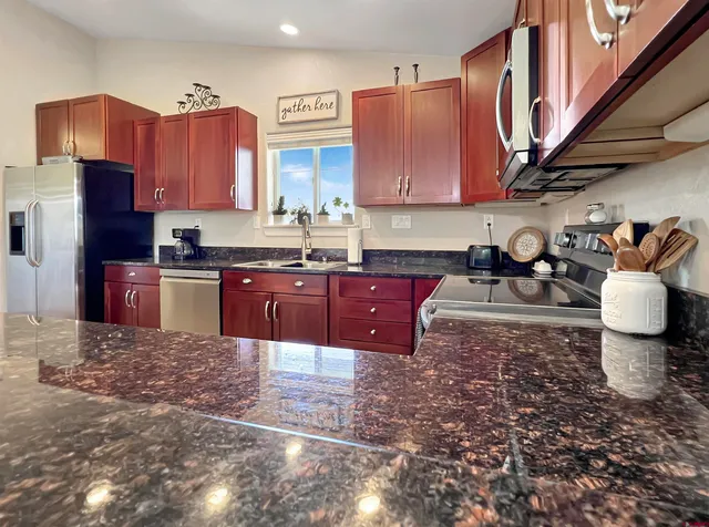 a large kitchen with a table and chairs