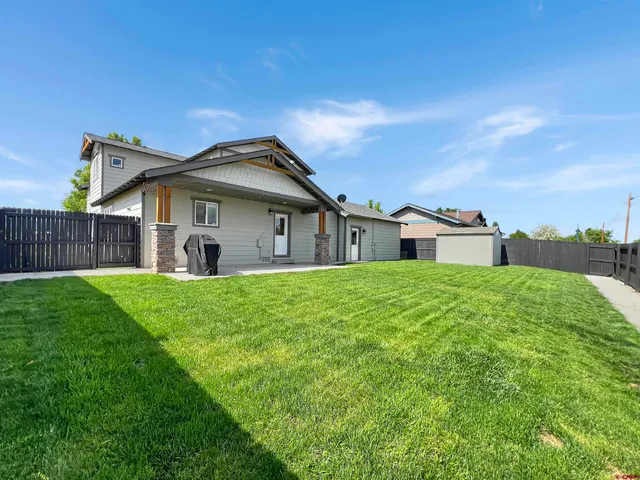 a view of a backyard with sitting area