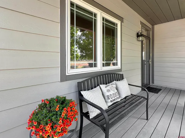 a living room with furniture a fireplace and wooden floor