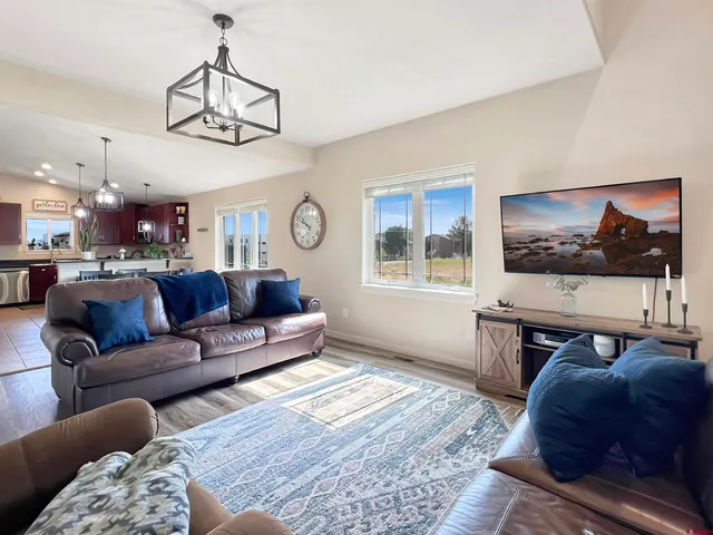 a living room with furniture and kitchen view