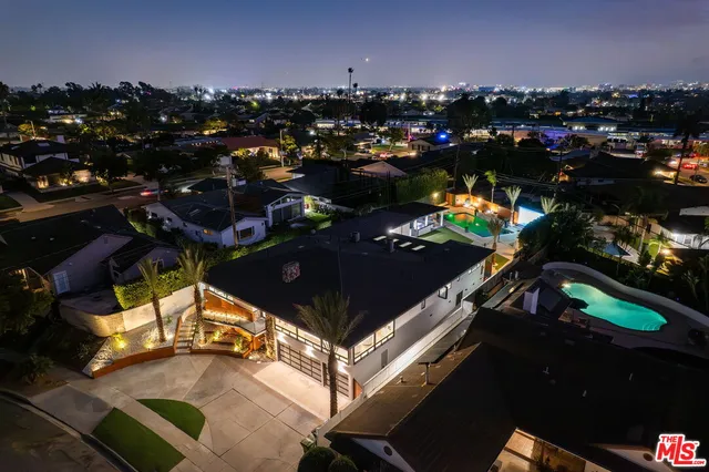 a view of a house with a swimming pool and a porch with furniture