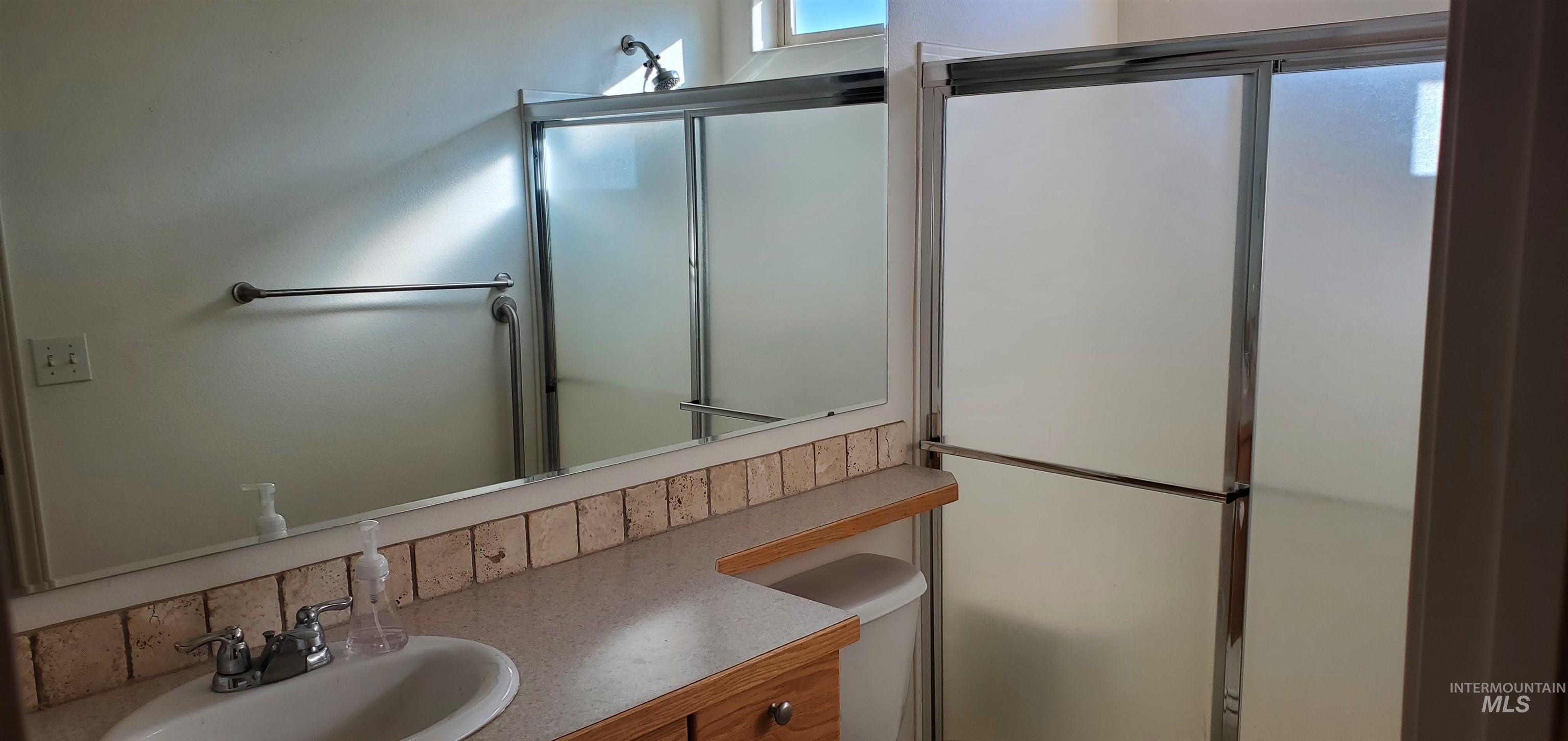 1000 North Rodeo Street Parma, ID 83660 - Photo 18 of 33 Bathroom with vanity and an enclosed shower