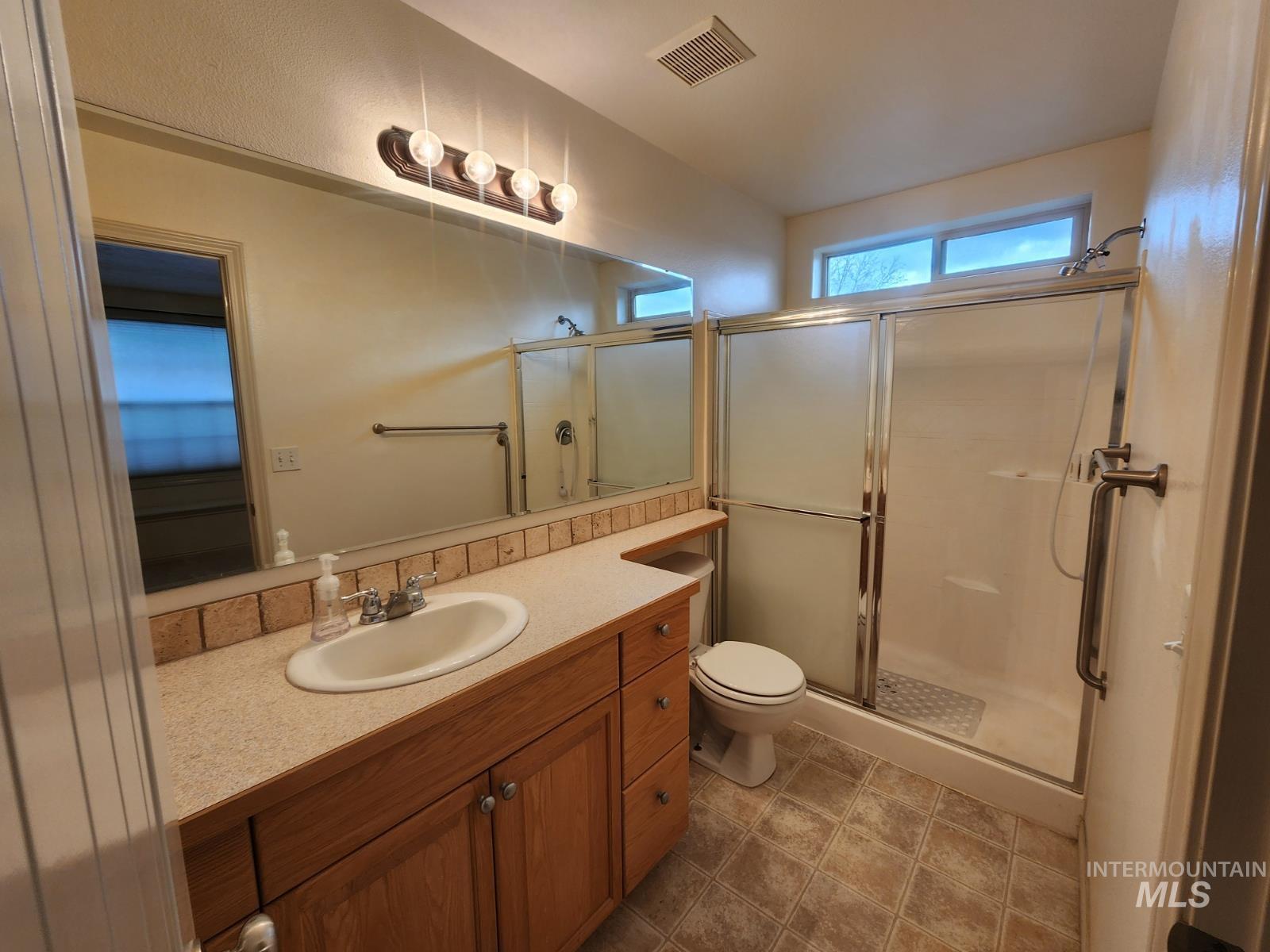 1000 North Rodeo Street Parma, ID 83660 - Photo 19 of 33 Full bathroom with vanity and a shower stall